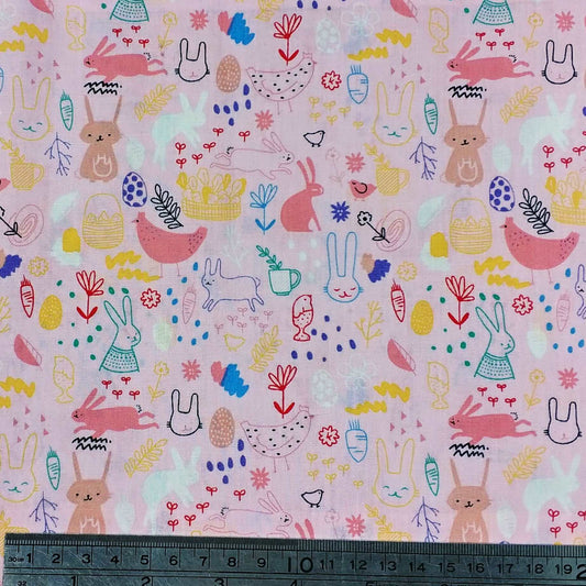 Fabric with colorful bunny and chick pattern on a pink background