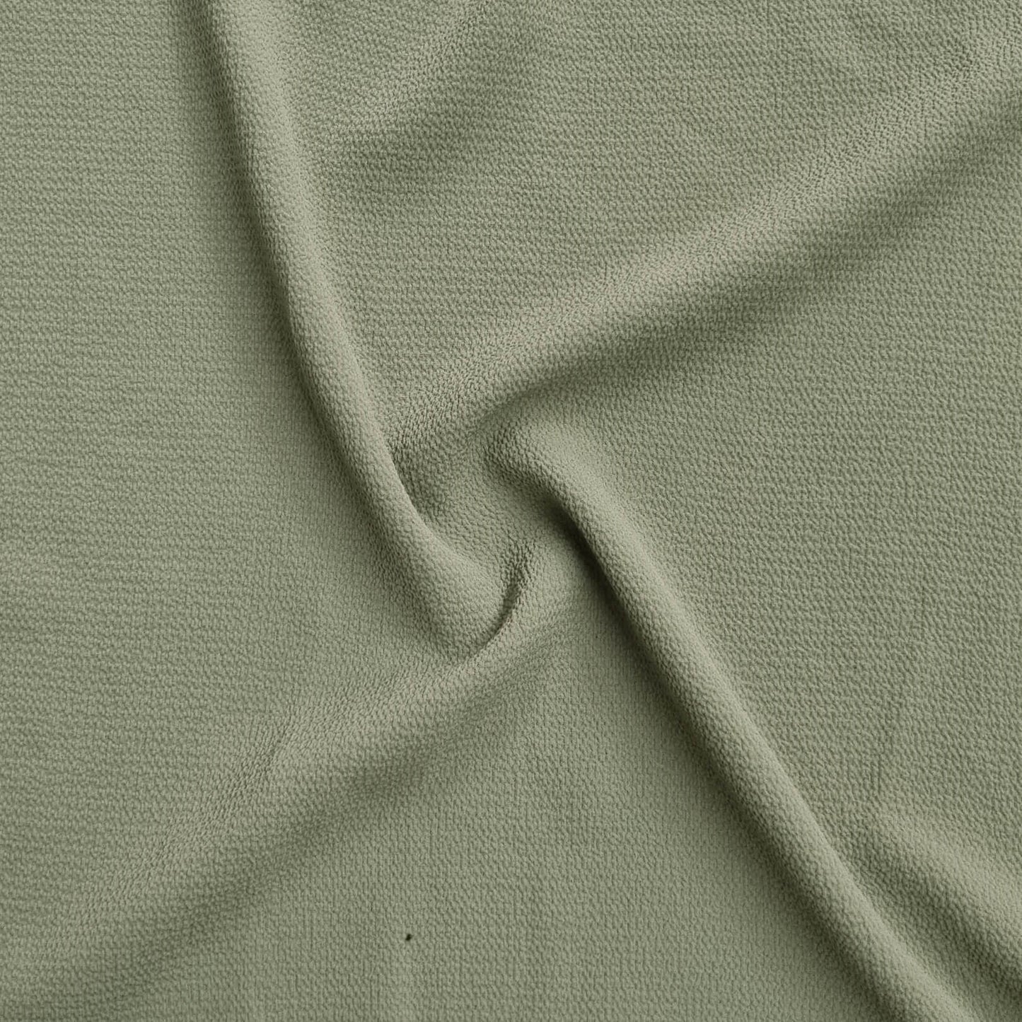 green fabric with a textured pattern