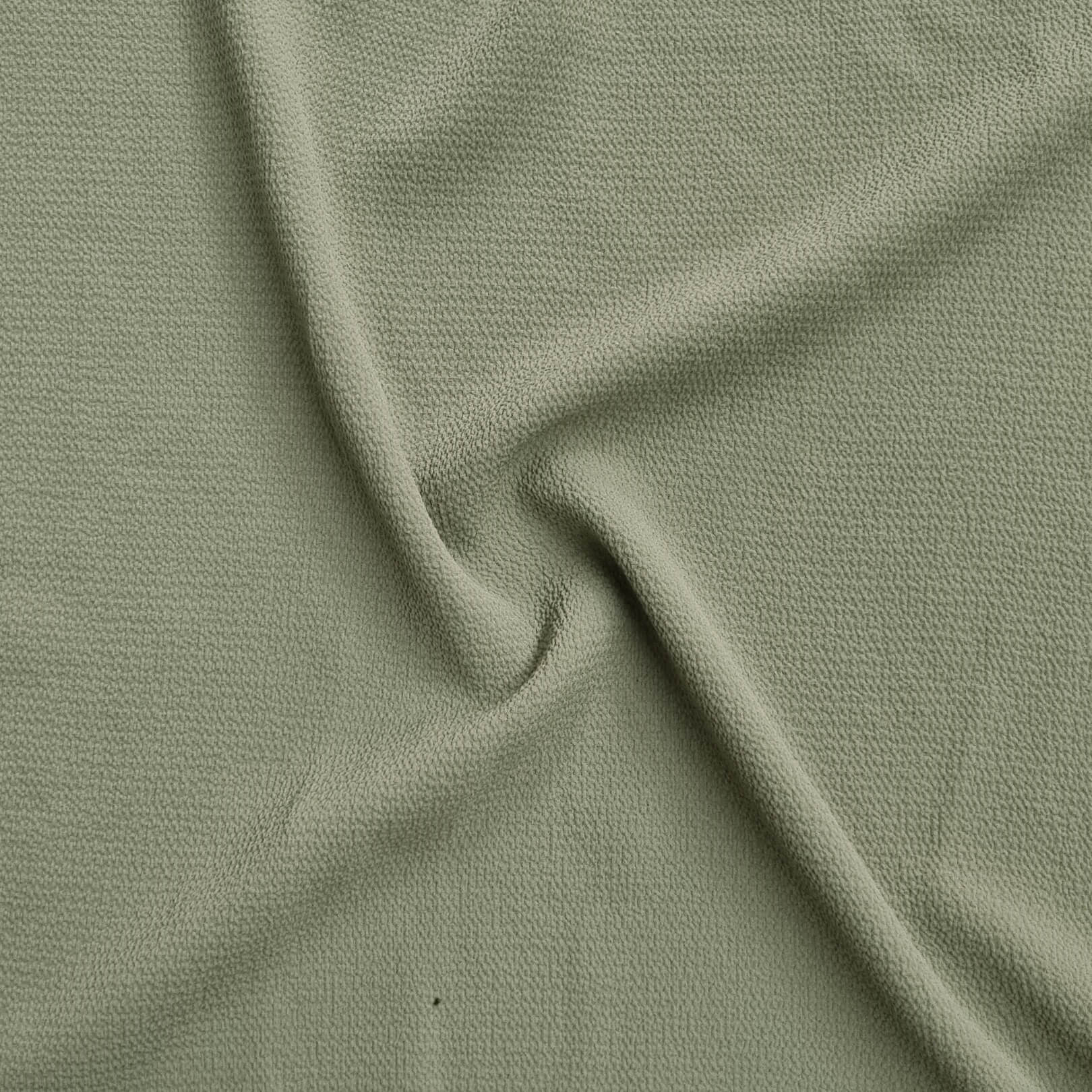 green fabric with a textured pattern