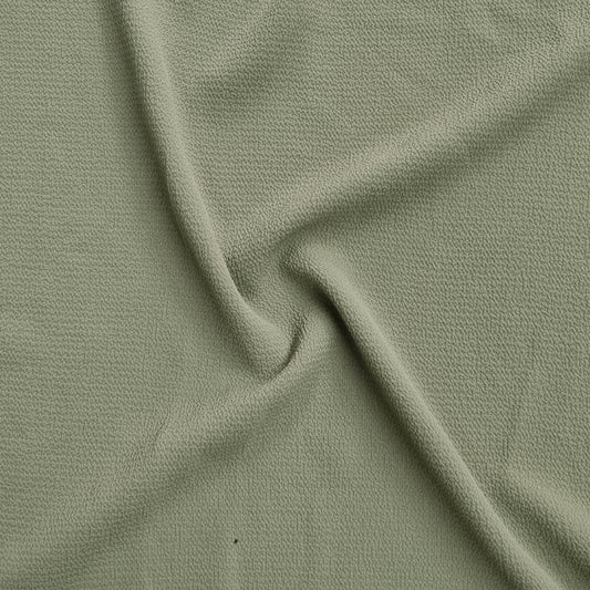 green fabric with a textured pattern