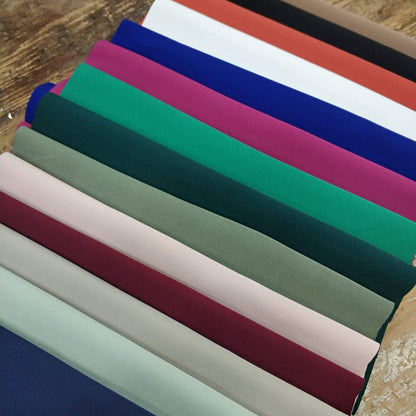 Stack of colorful woven fabric swatches