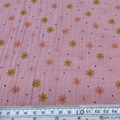 Floral patterned fabric on a pink bakround