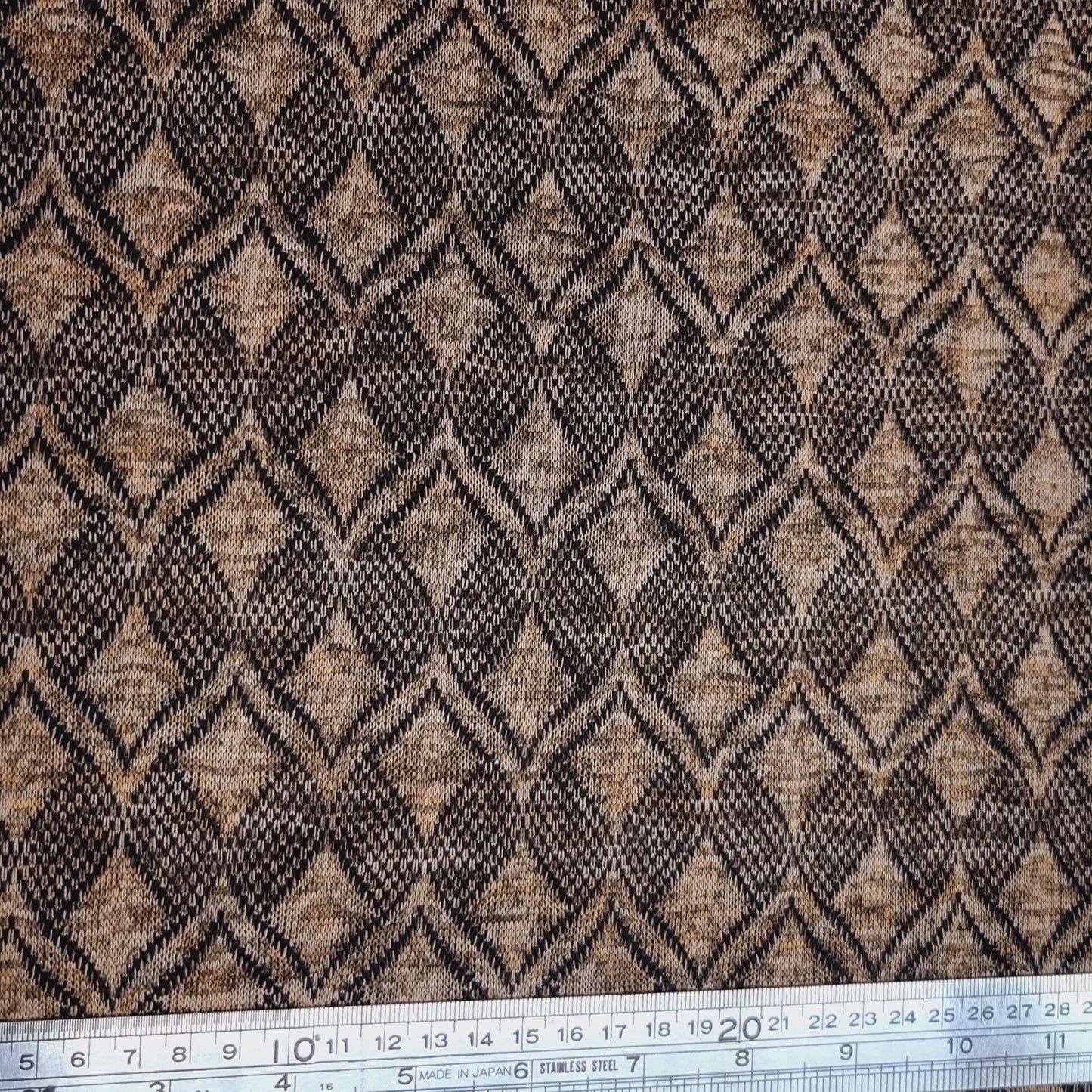 Textured fabric with a geometric pattern in black and brown