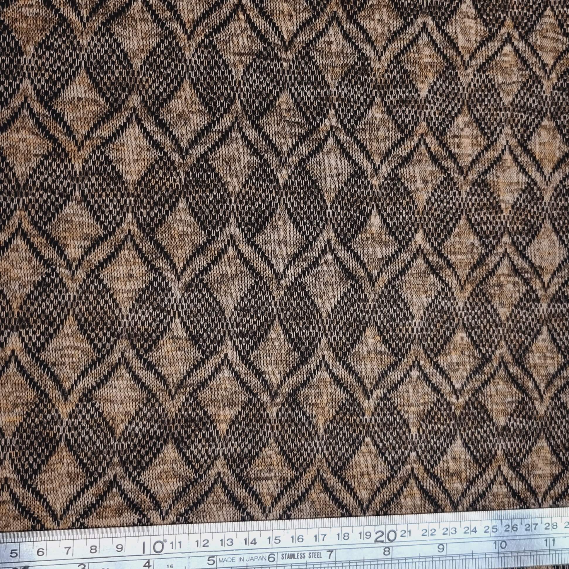Textured fabric with a geometric pattern in black and brown