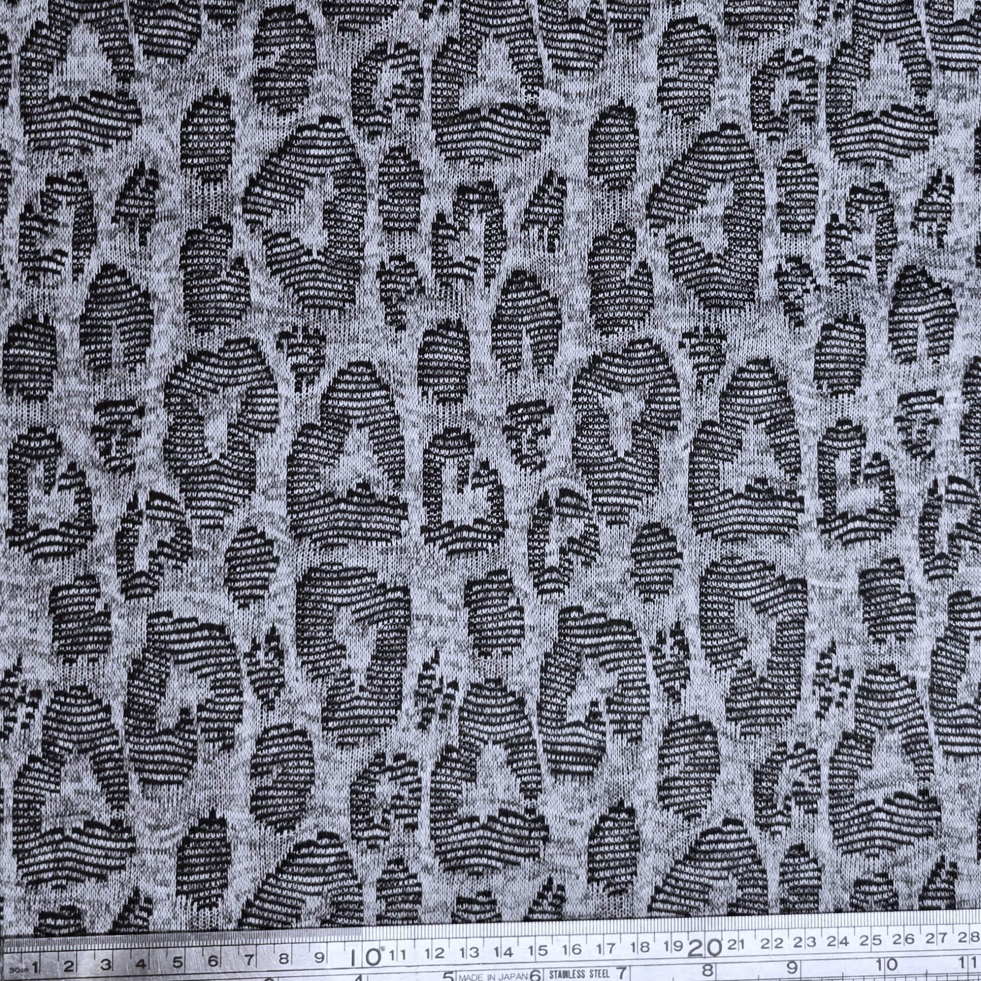 Jacquard fabric with a leopard print pattern in gray