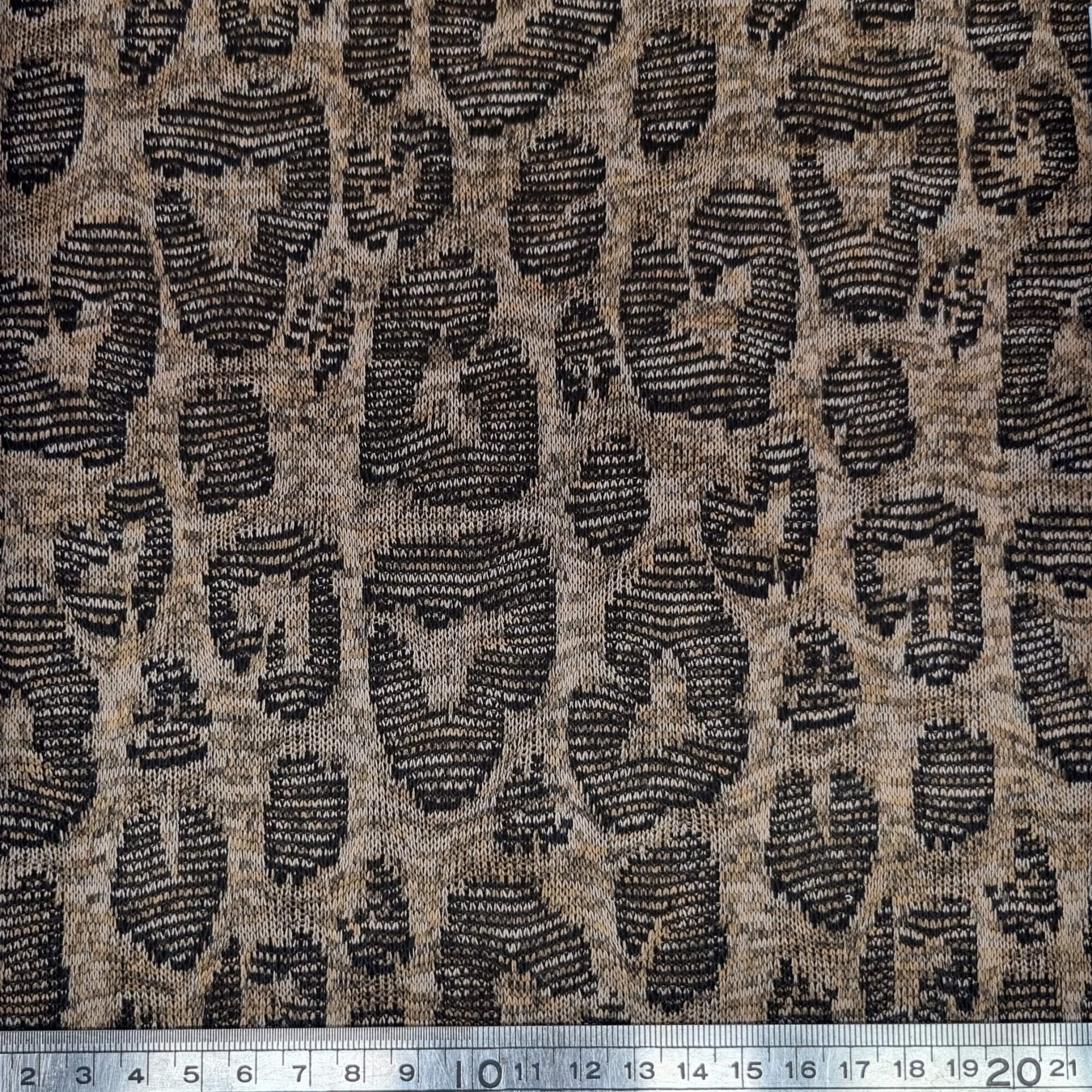 Jacquard fabric with a leopard print pattern in brown