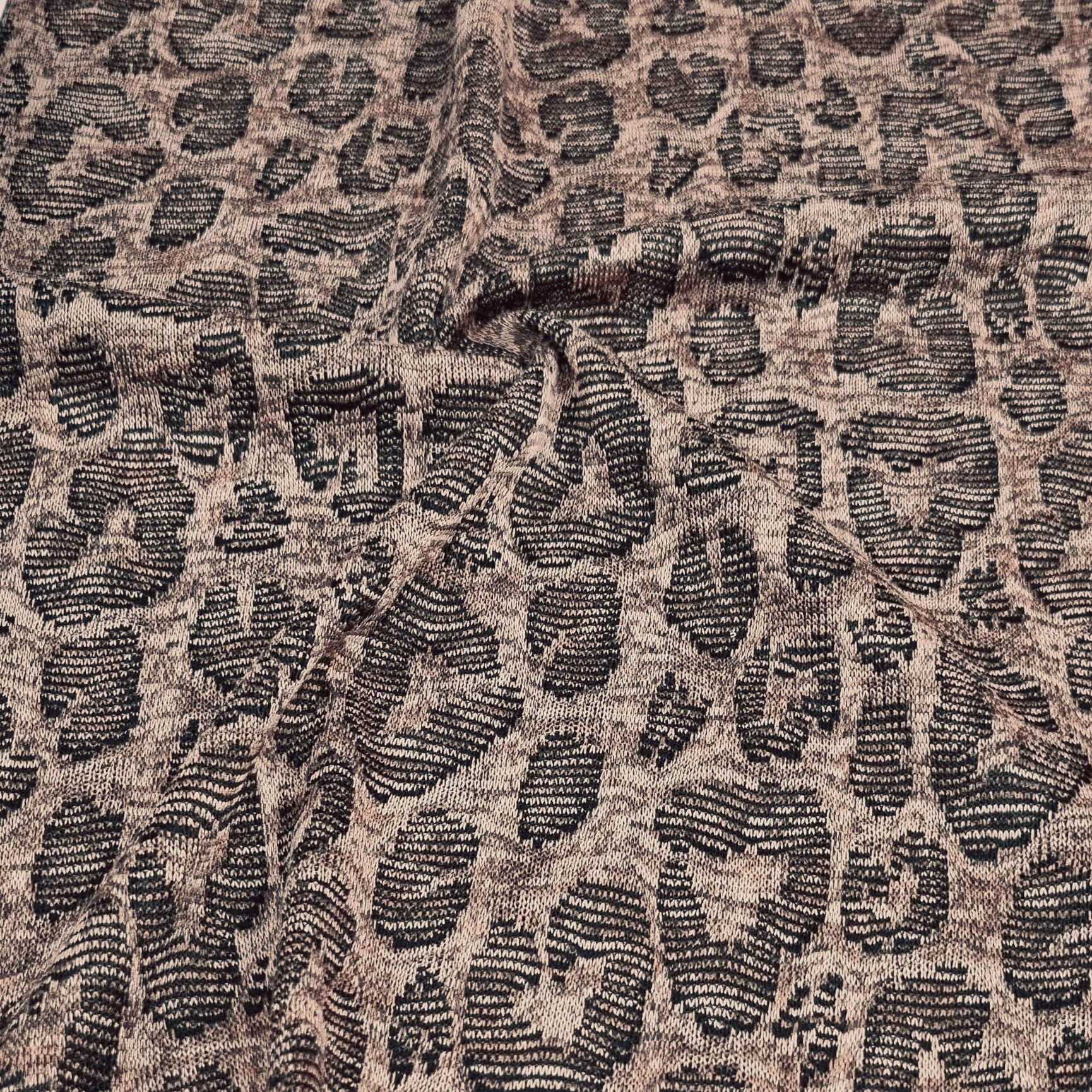 close-up of Jacquard fabric with a leopard print pattern in brown