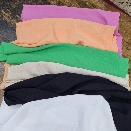 Stack Of Colorful Fabric Swatches With A Subtle Texture