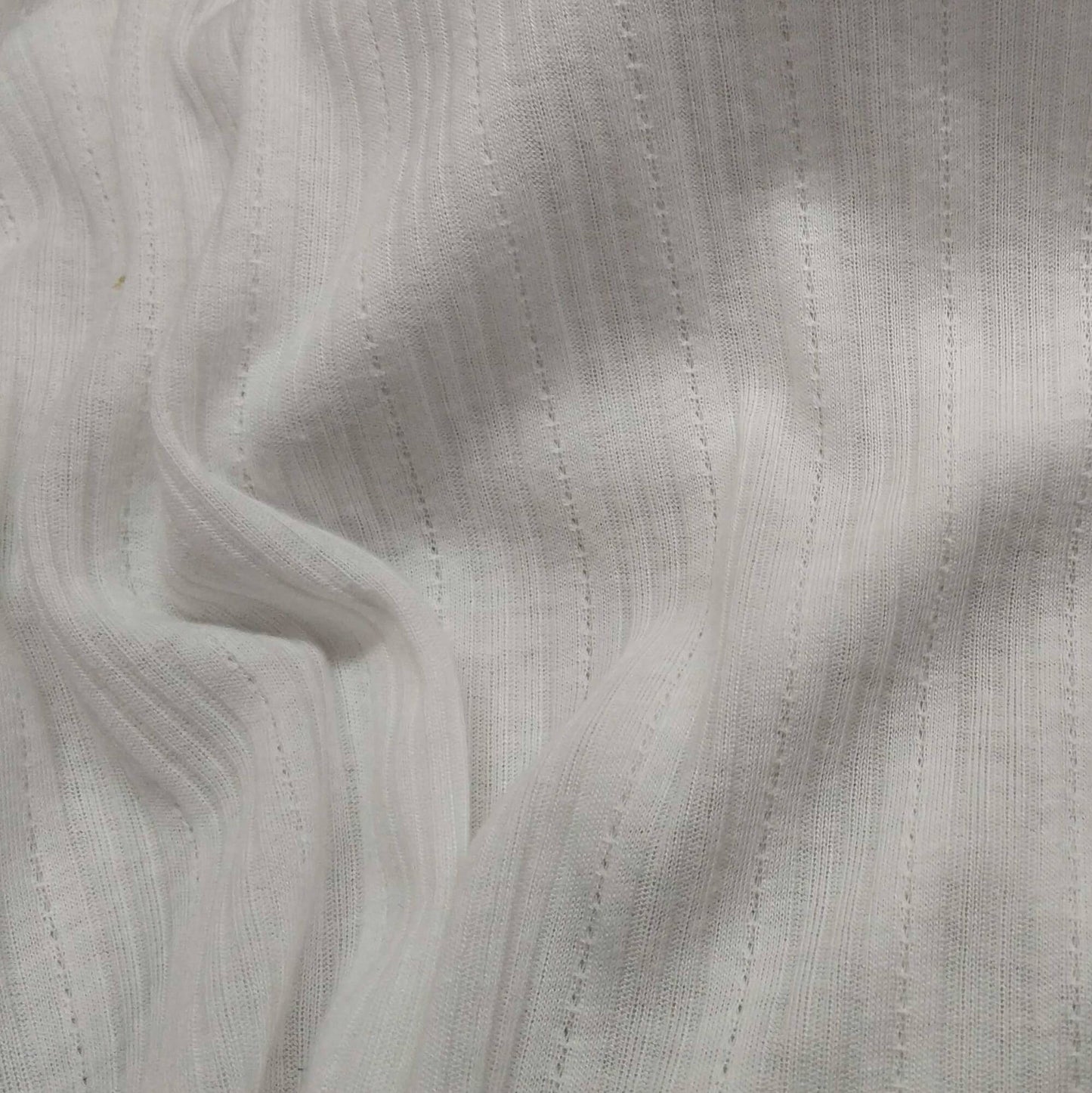 Ribbed knit fabric inspired by the soft texture and stretch of classic undershirts in off white