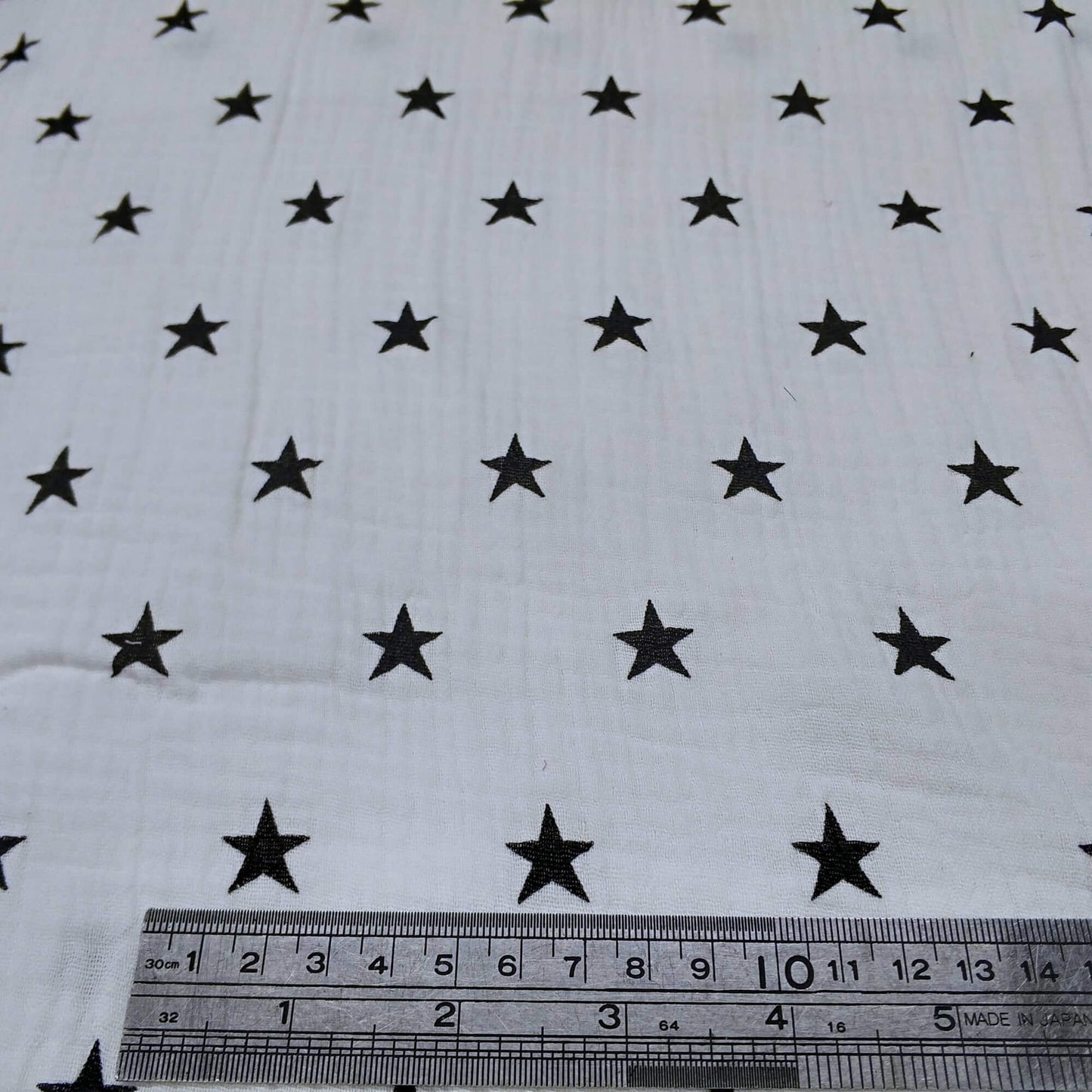 White fabric with black star pattern 
