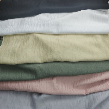 Woven fabric with a slightly crinkled and sand‑washed texture