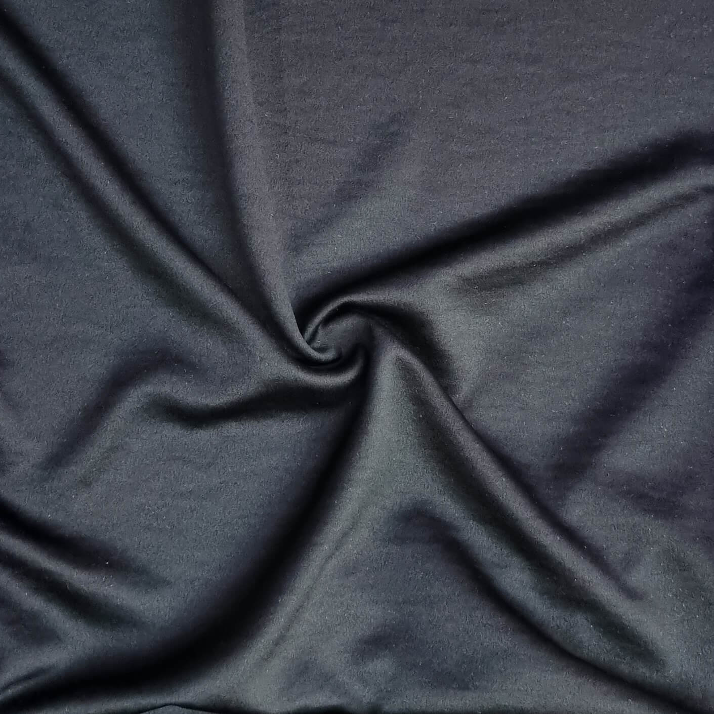 Woven fabric with a slightly crinkled and sand‑washed texture in black