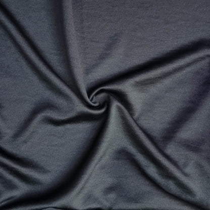 Woven fabric with a slightly crinkled and sand‑washed texture in black