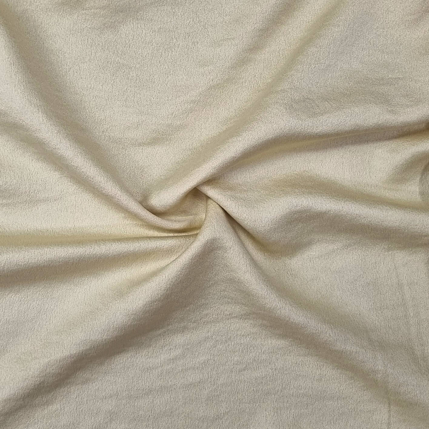 Woven fabric with a slightly crinkled and sand‑washed texture in yellow