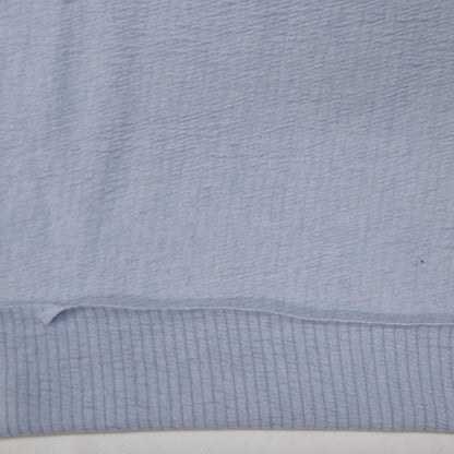 Sky blue knit fabric with a textured surface
