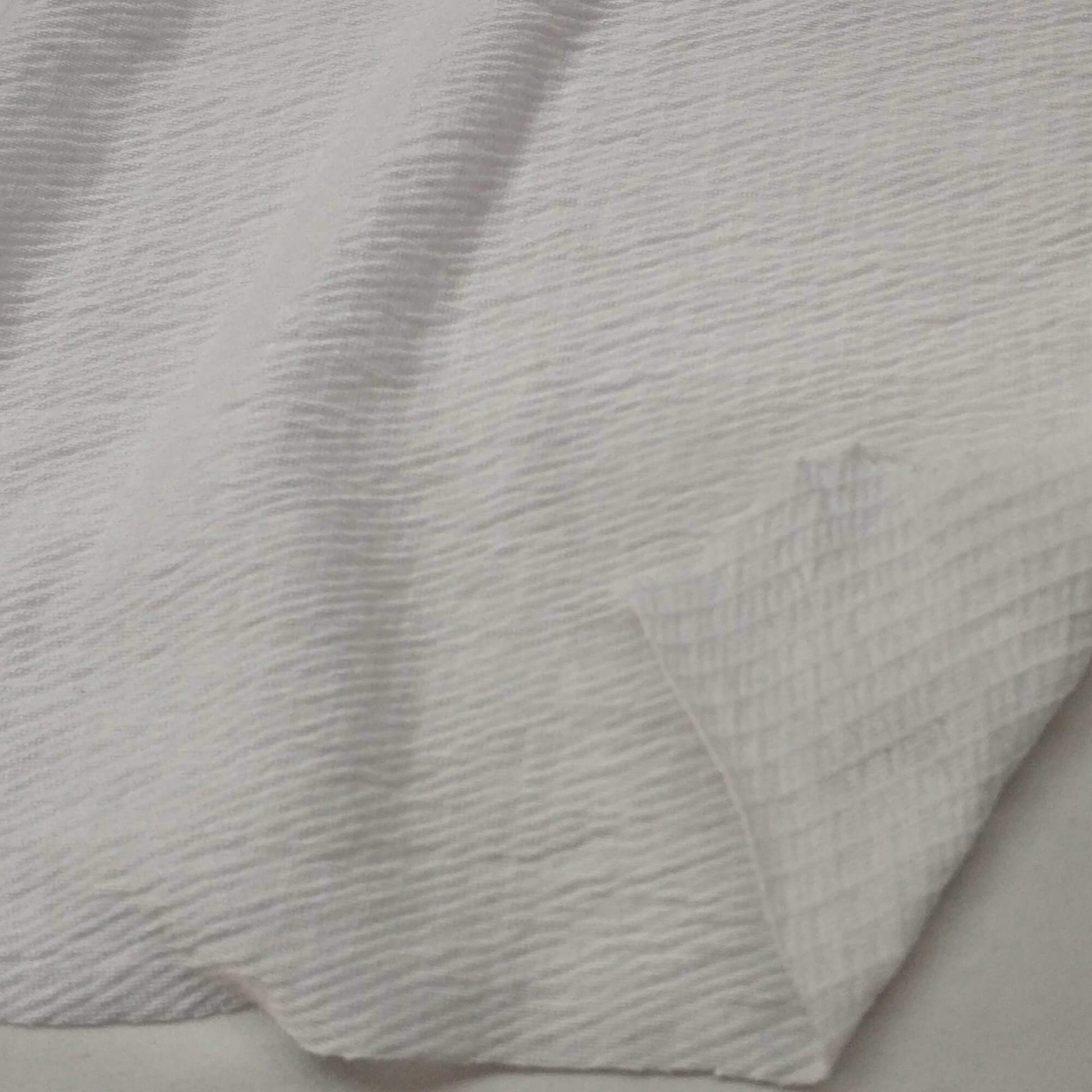 Ivory knit fabric with a textured surface