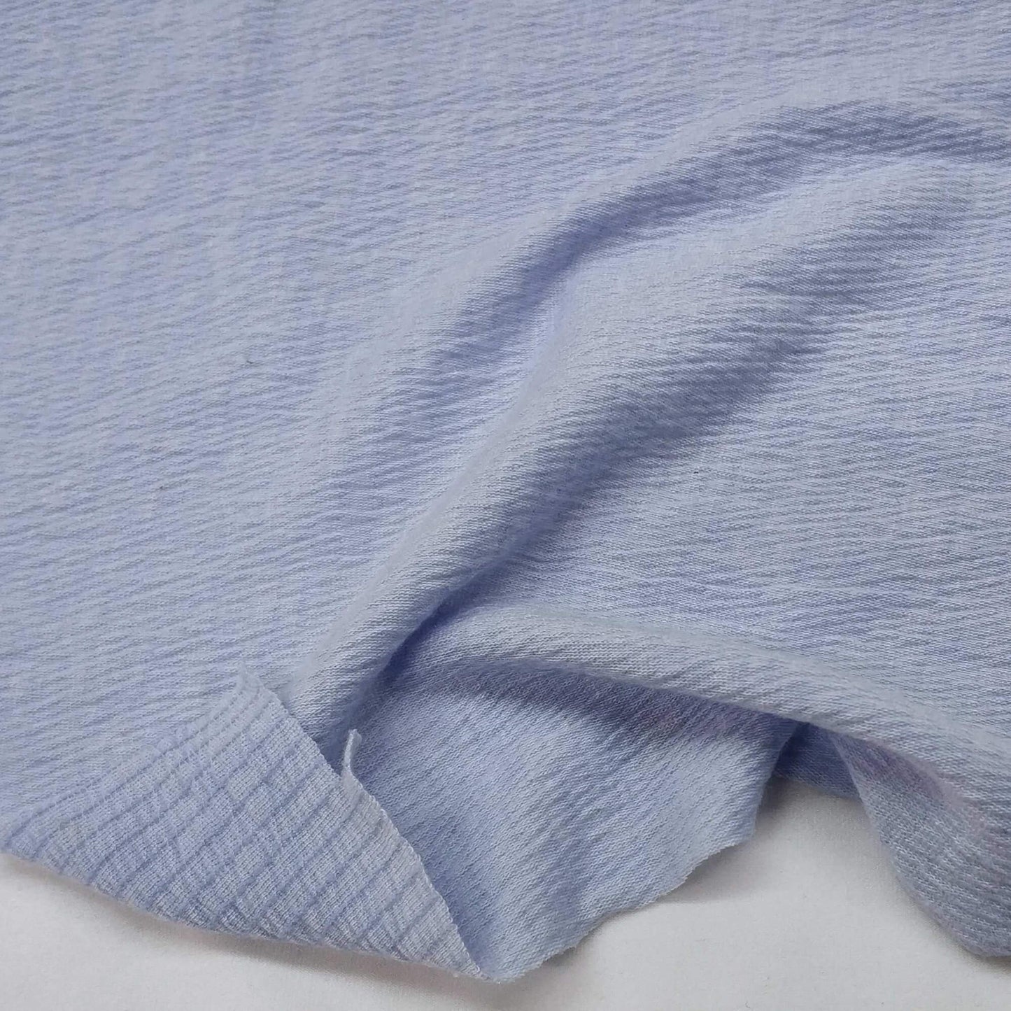 Sky blue knit fabric with a textured surface