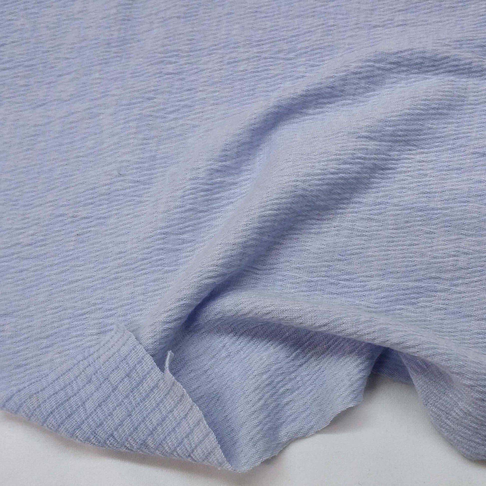Sky blue knit fabric with a textured surface