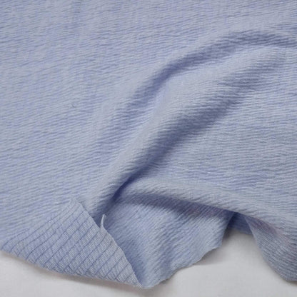 Sky blue knit fabric with a textured surface