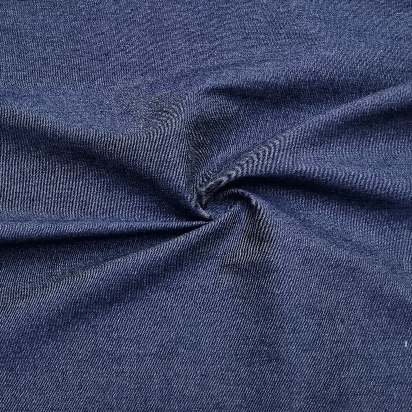 A washed lightweight denim fabric in dark blue
